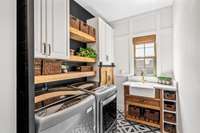 Laundry room with custom touches throughout. Cabinets and open shelving offer plenty of storage. The window brings in natural light!