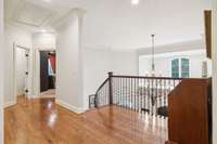 The expansive upper level hallway is accessible by two different staircases, both featuring custom iron spindles and beautiful wood banisters.