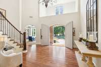 The gorgeous two story foyer is bright and cheery and is anchored by a sweeping staircase...a stunning entrance to this lovely home!