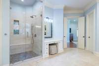 The oversized walk in shower with its built in bench, alcoves and beautiful tile work is luxurious!