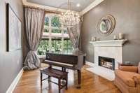 This dining room features a gorgeous travertine fireplace and breathtaking views from the expansive windows.