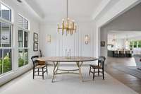 Formal dining room with custom millwork 2 sconces & chandelier