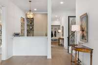 Wet bar adjacent to the kitchen features a wine refrigerator, sink & designer wallpaper~perfect for entertaining!