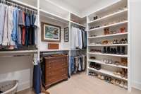 Primary walk-in closet with plenty of shelving