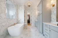 Luxurious primary bathroom~Owners replaced all the plumbing fixtures, cabinet hardware, lighting, & mirrors.