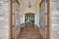 Real wood double doors leading to the entryway & living area