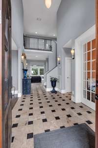 Real travertine tile floors welcome you to this incredible custom home.