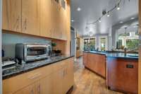 The contrasting stains on the cabinets and the island make for a beautiful color palette.