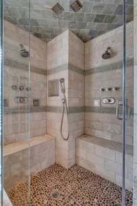 With multiple spray heads and plenty of room, this glass-enclosed shower feels luxurious.