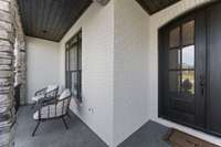 The Front porch has wood accents and beautiful stone work.