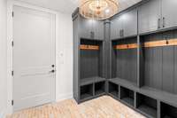 Mudroom with brick flooring and plenty of storage space