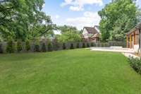 Back yard is large and newly sodded and landscaped with fence painted to match siding of home