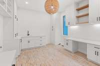 Laundry room and work station with beautiful brick floor