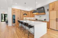 Kitchen features Thermador appliances: refrigerator, wine cooler, range and dishwasher.