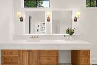 Dual vanities in primary bath on either side of room with mirrors edged in LED lighting.