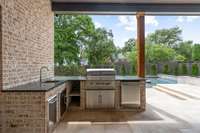 Outdoor kitchen with sink, ice maker and Coyote grill