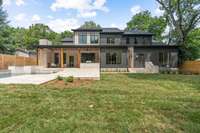 View of handsome home, pool, spa, outdoor kitchen and expansive backyard, Fence to match color of home.