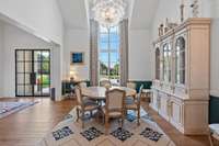 An abundance of natural light floods the formal dining room and its 16' ceiling. Adjacent to the butlers pantry and wet-bar which opens to the kitchen.