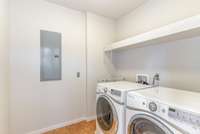 Large laundry room off of primary bedroom closet. Washer and dryer remain.