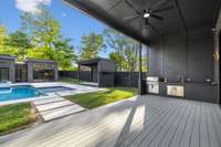 First of two covered porches -- the living room porch features an outdoor kitchen and gas fireplace