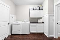 Large laundry room on main level with built in cabinets