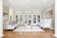 Living room area with glass doors that open to the screened in porch