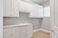 Laundry room with sink and cabinets