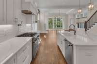 Upgraded kitchen countertops and oversized island. Custom cabinet drawer pullouts.