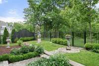 English garden-inspired outdoor design with custom trellis work and mature plantings adds depth and privacy to the setting.