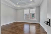 One of three upstairs bedrooms. Includes ensuite bathroom with tiled shower, extra-large walk-in closet, and additional cedar closet.