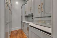 Custom butler's pantry with built-in beverage fridge.