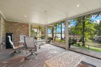 This screened-in porch has retractable screens for enjoying the summer nights without the pests!