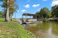 This home comes with it's own private roofed dock with electricity and water, a heavy duty lift system and its in a deep water cove! Your vessel will be protected from damaging large wakes and you can dock most large boats here.