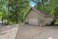 This garage measures 29'x29' - you easily fit 4 cars in tandem, car lift, is heated and has storage loft above. Just beyond the detached garage is a paved drive down to the lake (or RV parking). The sellers installed a 30 amp RV plug.