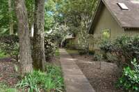 This long sidewalk brings your guests in from the driveway with a view of natural perineal flower beds and a view of the main channel of the lake off to the left