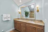 This beautiful travertine tiled Bathroom has ample storage in the double vanity and excellent lighting for getting ready each morning