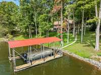 This dock has a new roof, is built of durable African wood and has a heavy-duty lift for boats of various sizes. With water and electricity at the dock, you have everything you need to maintain your boat at home!