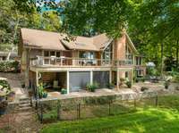 A view of the outdoor space. The roof is in excellent condition and is only 9 years old! The sellers bought this home with relatives in mind because of its accessibility and have put nothing but high-end quality appliances and systems into the home.