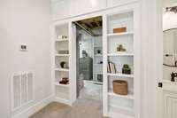 Hidden basement storage room or storm shelter.