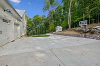 Large, level basketball are, with the chicken coop in the background.