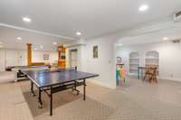 Space for a ping pong table, foosball, AND an air hockey table - plus a full sized refrigerator (conveys with the home), pull-out couch and more!  Seen to the right in this photo is the room that seller uses for crafting (large storage area also)