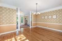 The formal dining room features William Morris wallpaper and leads directly into the fully renovated kitchen