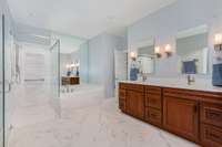 This bathroom was fully renovated and features a custom double vanity, marble floors, and an Italian towel warmer!