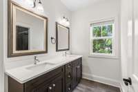 Large guest bathroom with a double vanity and seperate shower/water closet room.