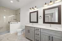 Huge secondary primary suite with double vanities, walk-in shower, custom tile work, and amazing light!