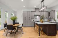 A dream kitchen! A breakfast area, oversized island, gas stove, and amazing natural lighting.