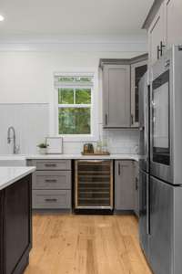 Your guests may never want to leave with your built-in wine fridge upon walking in to your kitchen!