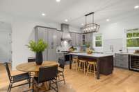 A dream kitchen! A breakfast area, oversized island, gas stove, and amazing natural lighting.