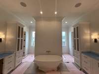 Primary Spa-like bath with huge walk-in shower, large soaking tub, 2 oversized vanities, 2 wardrobe closets, pre-wired speakers and lots of natural light *this home is under construction updated photo to come