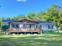 1700 Sq Ft Home & Campground RV lot. Lot has water, electric and sewer for 21 camp sites, 10 overflow and 1 pull through site.